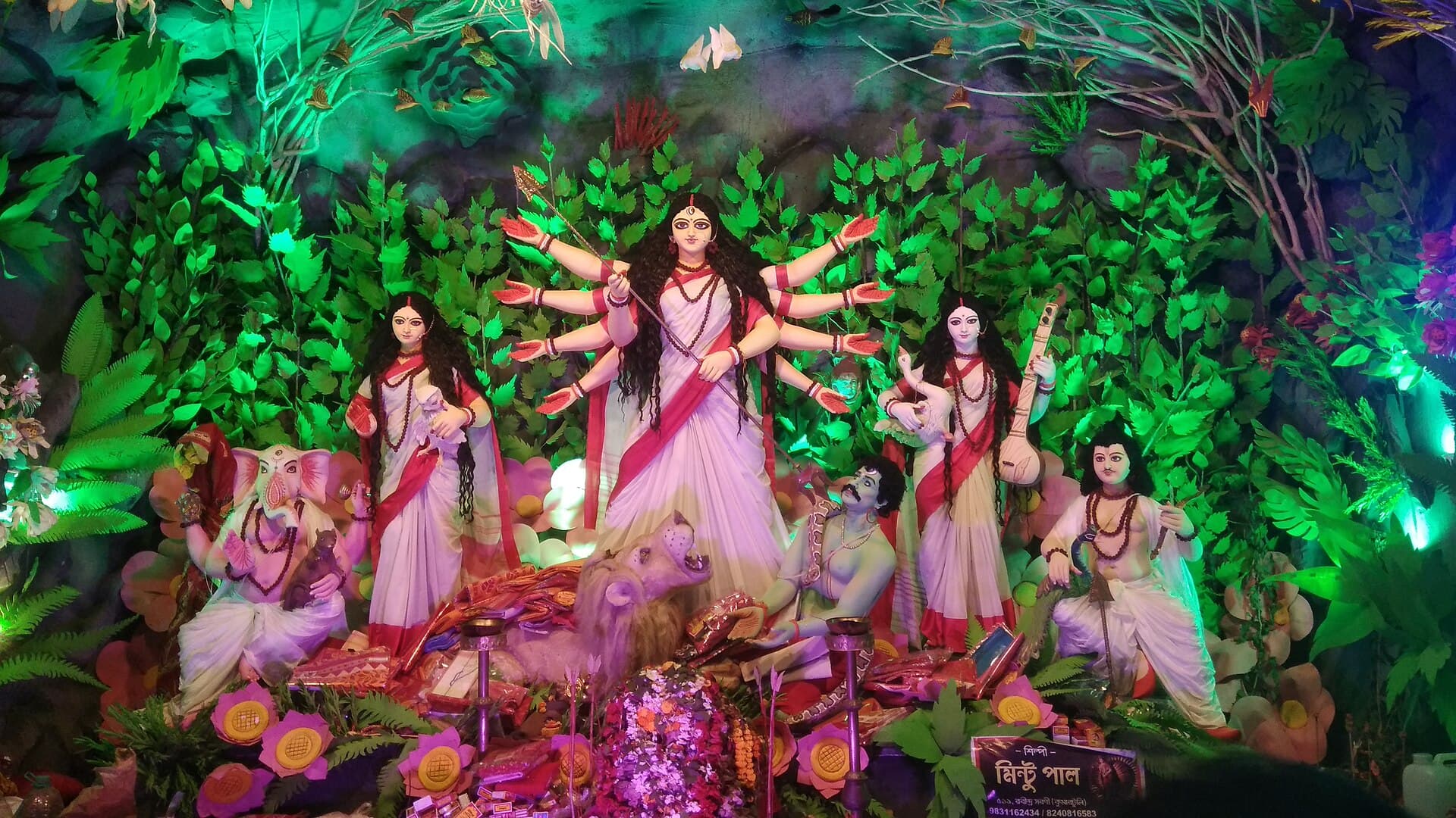 Durga idol illuminated inside a Kolkata Puja pandal